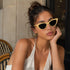 Butter Yellow | Occhiali da Sole Cat-Eye WYNIE Giallo Pastello, indossati da una ragazza con capelli castani e look estivo minimal e clean