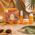 Michela Valenti Luminous Bloom Set Profumato | Body Mist, Crema Corpo e Doccia Schiuma dalla profumazione agrumata con Pochette in PVC giallo arancio e scena luxury aesthetic con dettagli estivi