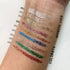Swatch degli eyeliner glitterati Wynie Cosmetics Sparkling Glitter Eyeliner, in tonalità neutre e colorate